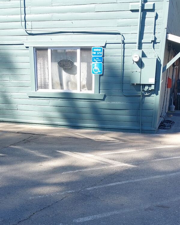 Faded ADA parking markings before re-striping — Amador County